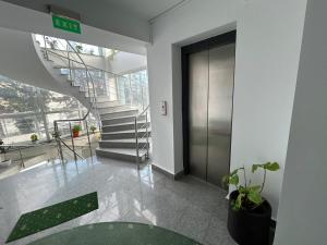 a lobby with a spiral staircase in a building at Hotel Atlantis in Tulcea +3 photos