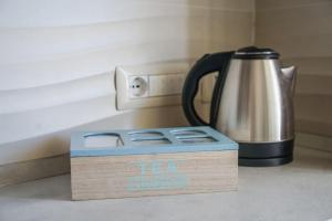 a tea kettle sitting on a counter next to a box at Nonna Carmela Holiday House in San Lazzaro Agerola