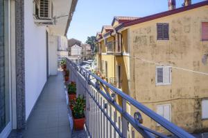 a balcony view of a street with buildings at Nonna Carmela Holiday House in San Lazzaro Agerola