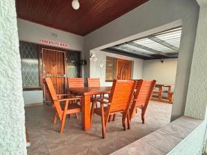 a wooden table and chairs on a patio at Fisherman's 6-Bedroom Family Home in St Lucia