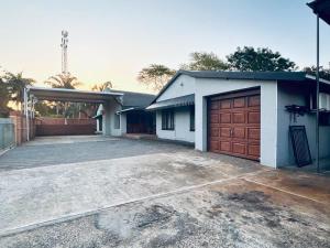 a house with a garage and a driveway at Fisherman's 6-Bedroom Family Home in St Lucia