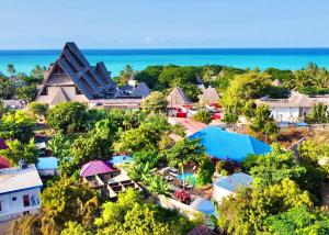 an aerial view of a resort with the ocean in the background at Ocean Breeze Boutique Hotel in Nungwi