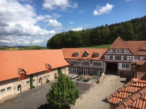 an overhead view of a group of buildings with orange roofs at Gut Beinrode in Kallmerode