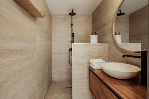 a bathroom with a sink and a mirror at Ellul Living in Il-Furjana