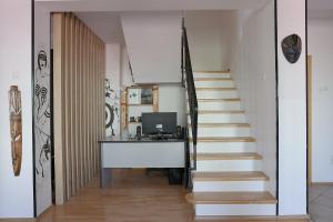 an office with a desk next to a staircase at Drenak Hostel in Skopje