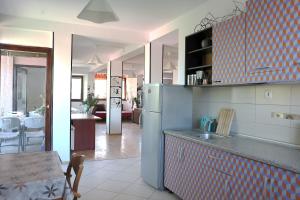 a kitchen with a refrigerator and a dining room at Drenak Hostel in Skopje +7 photos
