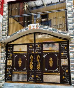 a building with a large wooden door with gold designs at Hotel Vishnu Priya Ayodhya in Ayodhya