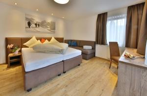 Postel nebo postele na pokoji v ubytování Hotel Garni Fiegl Apart