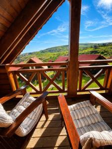 two chairs on the porch of a cabin with a view at Chalet O Refúgio 3 in Penhas da Saúde