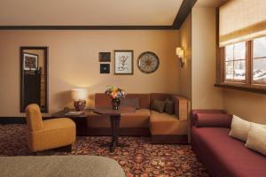 a living room with a couch and a table at Hotel Saint Roch in Courchevel
