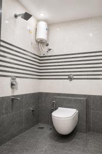 a bathroom with a toilet and black and white stripes at Hotel New Rajkamal in Aurangabad