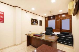 an office with a desk and chairs in a room at Hotel Shyam Villa - Govindpuri Metro in New Delhi