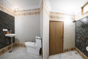 a bathroom with a toilet and a sink at Hotel Shyam Villa - Govindpuri Metro in New Delhi