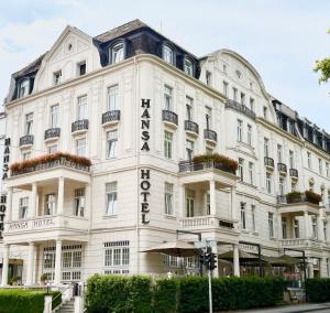 a white building with a sign on it at Star-Apart Hansa Hotel in Wiesbaden