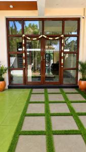 a front door of a building with grass at L2 Retreat in Kottakupam