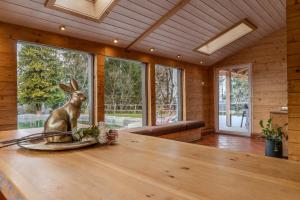 a dining room with a statue of a rabbit on a table at Luxury Chalet with Swimming Pond Nature Escape Upper Austria in Sankt Johann am Walde