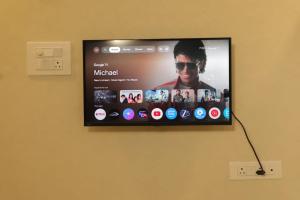 a flat screen tv hanging on a wall at Hotel New Rajkamal in Aurangabad +13 photos