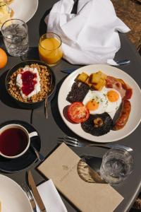 a table with two plates of breakfast food on it at Aysgarth Falls Hotel & Restaurant in Aysgarth