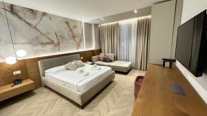 a hotel room with a bed and a couch at Moncler Residence in Ksamil