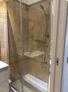 a shower with a glass door in a bathroom at Carducci Sunrise in Tortoreto Lido +15 photos