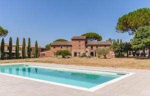 an empty swimming pool in front of a house at Tuscany Heritage Exclusive - La Ceppa in Sinalunga