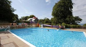 a large swimming pool with people in the water at Cosy Cabin in Bucks Mills