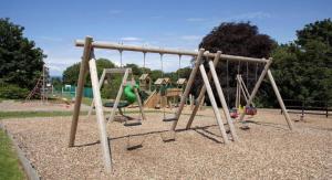 an empty park with a playground with swings at Cosy Cabin in Bucks Mills
