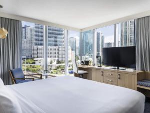 a hotel room with a large bed and a large window at Novotel Miami Brickell in Miami +132 photos