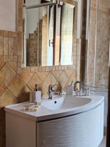 a bathroom with a sink and a mirror at B&B ADU Civitavecchia in Civitavecchia