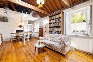 a living room with a couch and a table at Biddy's Cottage Dalkey in Dublin +3 photos