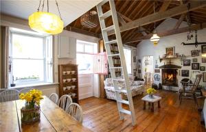 a living room with a loft bed and a table at Biddy's Cottage Dalkey in Dublin