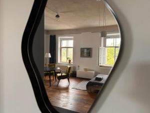 a living room with a table and a dining room at Room 0 in The White House Residence in Kuldīga +1 photo