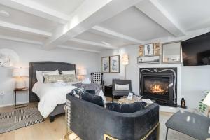 a living room with a bed and a fireplace at Private Oceanfront Suite Hot Tub & Fireplace in Lunenburg
