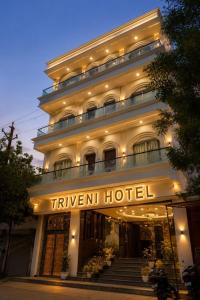 a hotel with a sign on the front of it at Triveni Hotel And Restaurant in Barsāna