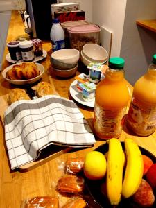 a table with a bunch of food and bottles of juice at Pyrenean Pursuits in Biert