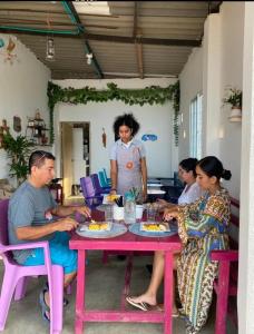 a group of people sitting around a table eating food at brisas costeña in Santa Marta