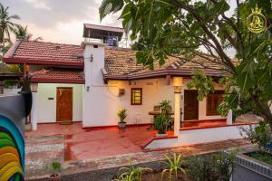 a white house with a red roof at T P Villas in Nilaveli