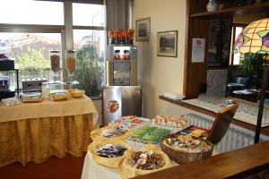 a table with a variety of pastries on it at Hotel Bodoni in Florence