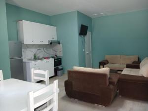 a living room with a couch and a table at SeaSideGolem Apartments in Golem