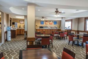 a restaurant with tables and chairs and a bar at MainStay Suites Edinburg South in Edinburg