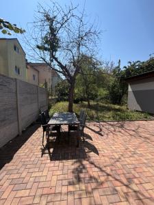a table and chairs on a brick patio at Černá Růže- apartmán 2 in Pilsen