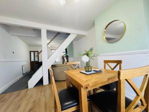 a dining room and living room with a table and chairs at Bolton Terrace - 2 Bedrooms - Sleeps 4 in Workington