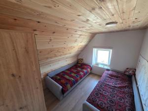 a bedroom with a bed and a couch in a room at Miris Katuna - Sinjajevina in Šavnik +19 photos