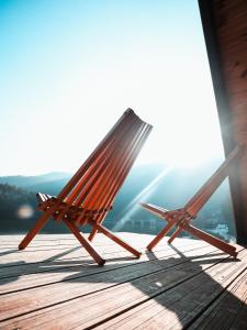 two wooden chairs sitting on a wooden deck at Ovcharka House in Međuvršje