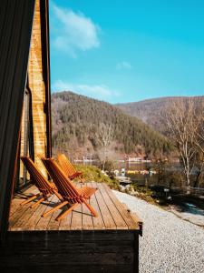 two chairs sitting on a deck with a view at Ovcharka House in Međuvršje