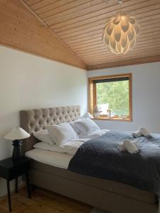 a bedroom with a large bed and a chandelier at Tromsø Panorama in Tromsø