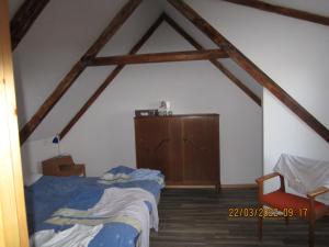 a bedroom with a bed and a dresser in a attic at Mysig huset in Strömsnäsbruk