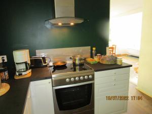 a kitchen with a stove and a counter top at Mysig huset in Strömsnäsbruk