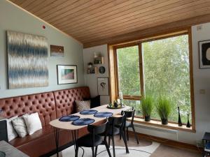 a dining room with a table and chairs and a window at Tromsø Panorama in Tromsø