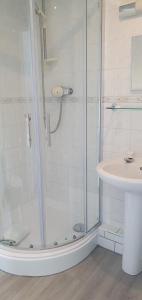 a bathroom with a shower and a sink at Seabrook House Hotel in Hythe +25 photos